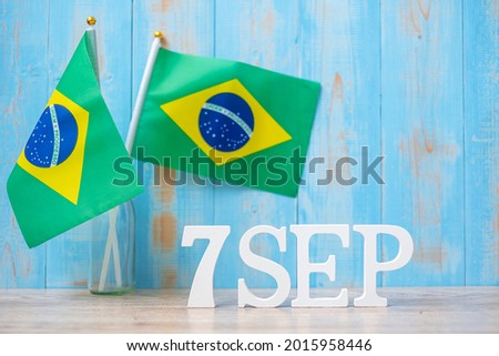 Wooden text of September 7th with miniature Brazil flags. Independence day of Brazil and happy celebration concepts