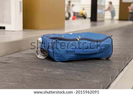 Baggage claim. Luggage close-up on a conveyor belt at the international airport. The concept of forgotten, lost luggage. Royalty-Free Stock Photo #2015962091