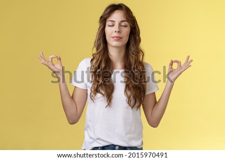 Mind wonders away problems. Girl om chanting meditation close eyes smiling delighted found peace relaxation feeling relieved breathing buddhist practice hands sideways mudra lotus pose do yoga Royalty-Free Stock Photo #2015970491