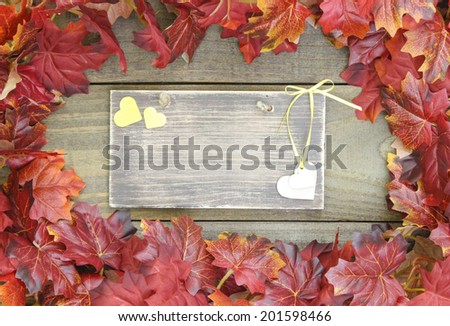 Autumn leaves border rustic wood sign with yellow hearts