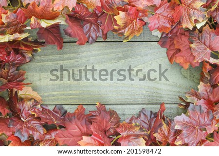 Autumn leaves border rustic wooden background