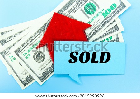 banknotes, conversation bubbles, red paper houses with the word SOLD