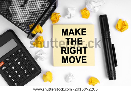 Business concept. On the table is a calculator, crumpled paper, a marker and note paper with the inscription - MAKE THE RIGHT MOVE