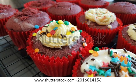 Selective focus view of home made bakery, gluten free mini cupcake with fun decoration with cream cheese and colorful sprinkles on the top. Home party, kid afternoon healthy snack.