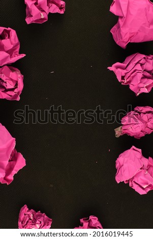 beautiful picture of pink crumpled paper on black vivid abstract background