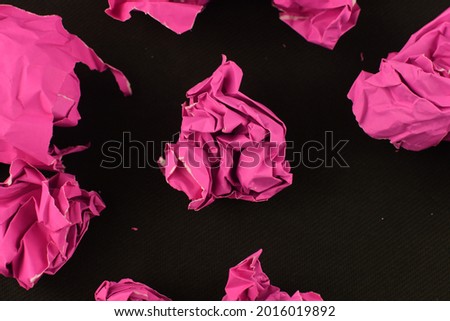 beautiful picture of pink crumpled paper on black vivid abstract background