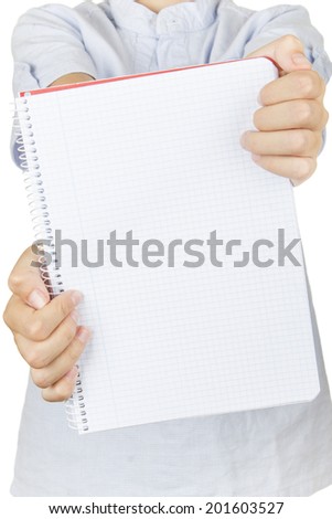 Child on a white background showing his notebook to the camera.