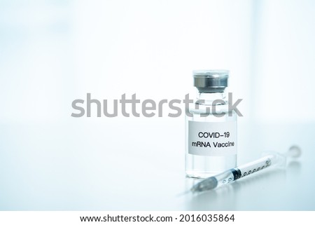 Coronavirus 2019 or SARS 2019-nCoV cure vaccine in mRNA technology and medical needle close up. mRNA vaccine in bottle and needle for injection. COVID19 vaccine.