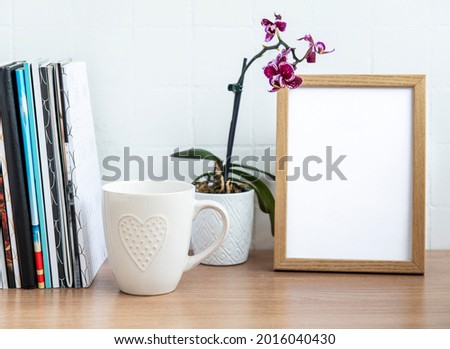 Office desk with stack of notepads,  office supplies and house plants
