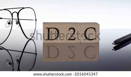 Close-up Of D2C Wooden Blocks on black background with glasses and pen