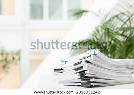 Stack of documents on table in office