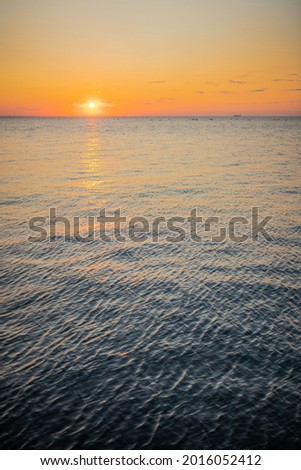 Photo of the sea at sunrise or sunset. Beautiful seascape. Natural composition.