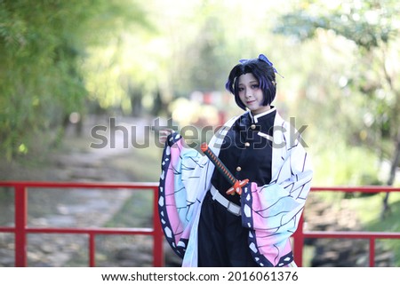 Japan anime cosplay portrait of girl with comic costume with japanese theme garden