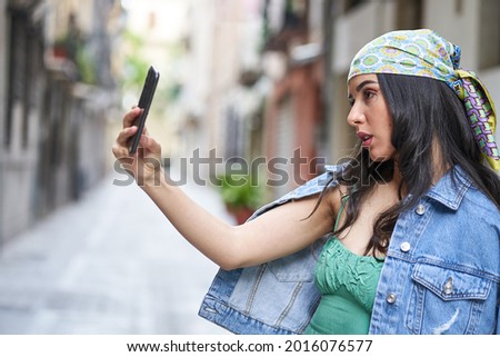 young woman takes a picture with her smartphone when sightseeing