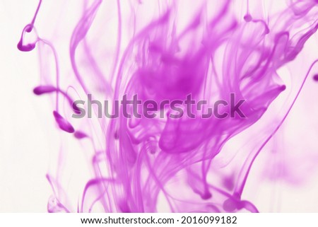 Ink in water isolated on white background. Purple colors. Colors explosion. Thin line, abstract background.