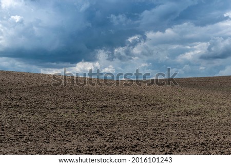 Thunderstorm clouds over the field