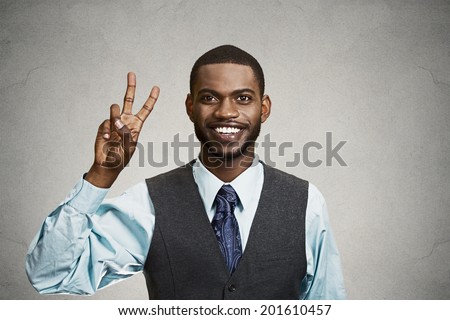 Closeup portrait, headshot young man, student holding up peace, victory, two sign , isolated black background. Positive human emotion, facial expressions, symbols, attitude communication. Life success