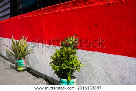 The walls of the hallway of the house are colored with the Indonesian flag, red and white, in commemoration of Indonesia's independence day