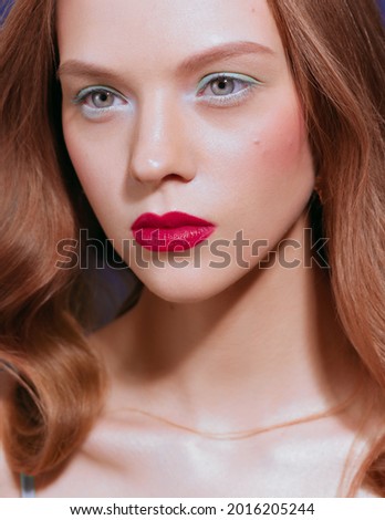 Young woman with long red wavy hair. After retouching portrait