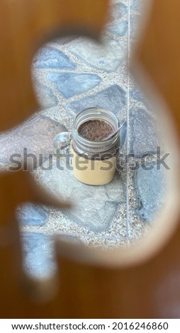 A mug of coffee milk on the floor view around of  wood