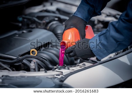 Car mechanic open car hood repairs system checking oil motor level for refill super Coolant and clean in car garage service. Royalty-Free Stock Photo #2016261683