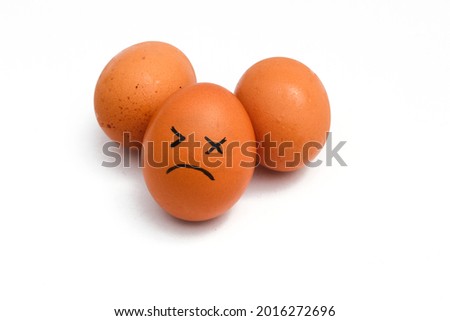 a Group of brown chicken eggs with tired faces isolated on white background.