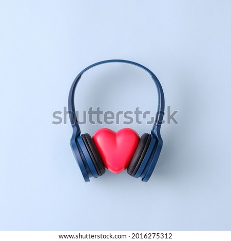 Trendy romantic concept with party headphones and heart listening to disco. Minimal creative idea.