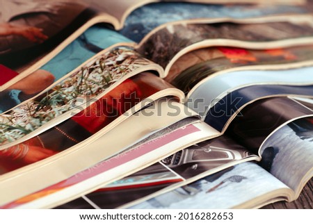 Stack of magazines .Closeup background of a pile of old magazines with bending pages
