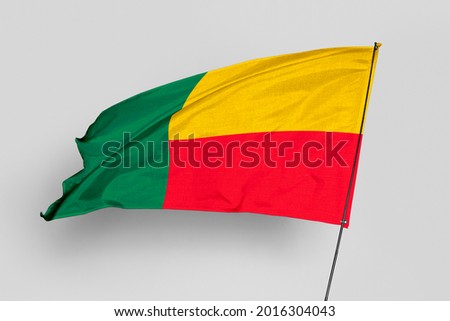 Benin flag isolated on white background. National symbol of Benin. Close up waving flag with clipping path.