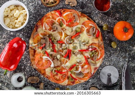 Vegetarian pizza with tomato, paprika, mushrooms and onion
