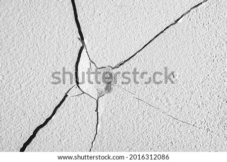 Cracks in the concrete wall. Royalty-Free Stock Photo #2016312086