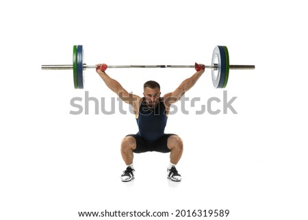 Full length portrait of man in sportswear exercising with a weight isolated on white background. Fit young muscular caucasian model with barbell training at abstract gym. Sport, weightlifting concept Royalty-Free Stock Photo #2016319589