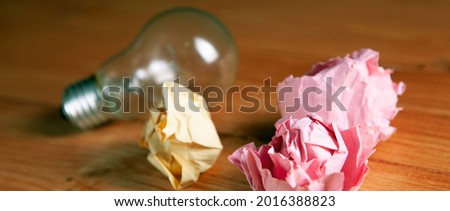 light bulb and crumpled papers on the table
