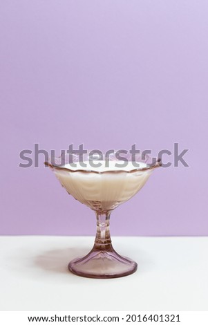 Handmade vintage candle shot in a studio in front of colored (purple) background