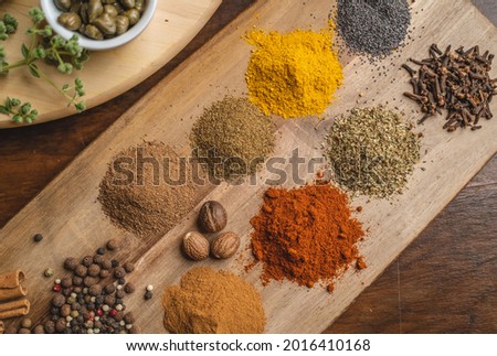 Top view mix of Indian spices and herbs on a table background with space for vegetable design, healthy lifestyle, spices, herbs or food content.