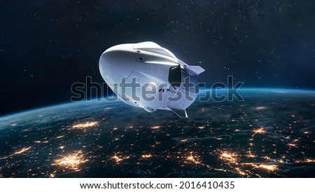 Spacecraft on orbit of Earth. Spaceship in outer space. Future and commercial tourism. Earth at night. Elements of this image furnished by NASA Royalty-Free Stock Photo #2016410435