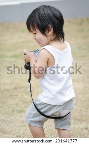 Little asian baby boy with camera