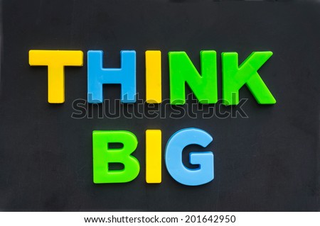 think big concept words on blackboard