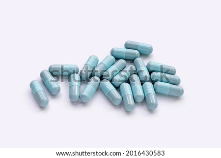 Blue capsules on white background