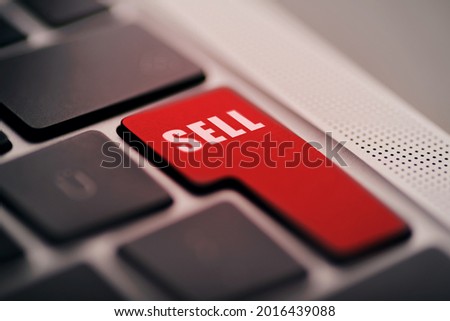 Close up shot of Enter button laptop computers enter button with Sell text written on red.