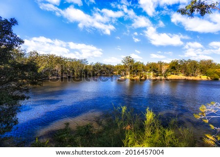 Scenic blue Lake Parramatta in Greater Sydney on a sunny day - walking track around the lake. Royalty-Free Stock Photo #2016457004