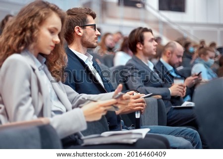 young business people using their smartphones during the workshop. Royalty-Free Stock Photo #2016460409