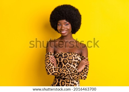 Photo of pretty sweet dark skin woman dressed leopard outfit smiling arms crossed isolated yellow color background