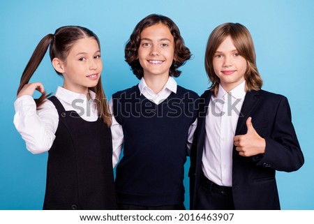 Photo portrait school mates smiling in uniform showing thumb-up sign isolated pastel blue color background