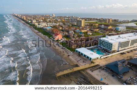 drone view high above the Beach Vacation Travel Destination of South Padre Island , Texas , USA long pier and many condos and buildings across the island Royalty-Free Stock Photo #2016498215