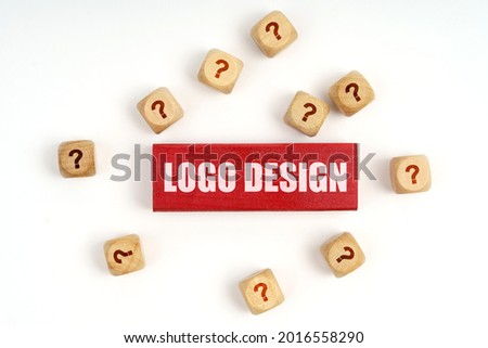 Question concept. On the table are cubes with questions and a red plaque with the inscription - Logo Design Royalty-Free Stock Photo #2016558290