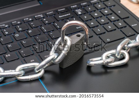 an iron chain, an open padlock on a computer keyboard the concept of data protection censorship on the Internet. High quality photo Royalty-Free Stock Photo #2016573554