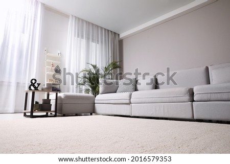 Living room interior with soft carpet and stylish furniture Royalty-Free Stock Photo #2016579353
