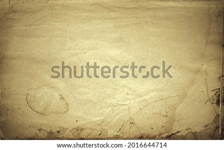 Photo of the texture of old yellowed papyrus paper with spots and crumpled edges