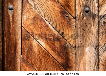 Detail of old aged wooden entrance door (in one of medieval house in Prague Lesser town). Nice wooden texture and structure.